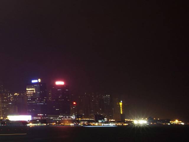 City skyline at night with skyscapes being lit